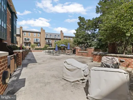 a view of a terrace with furniture and a fire pit