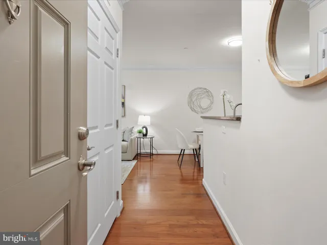 a view of a hallway with wooden floor and staircase