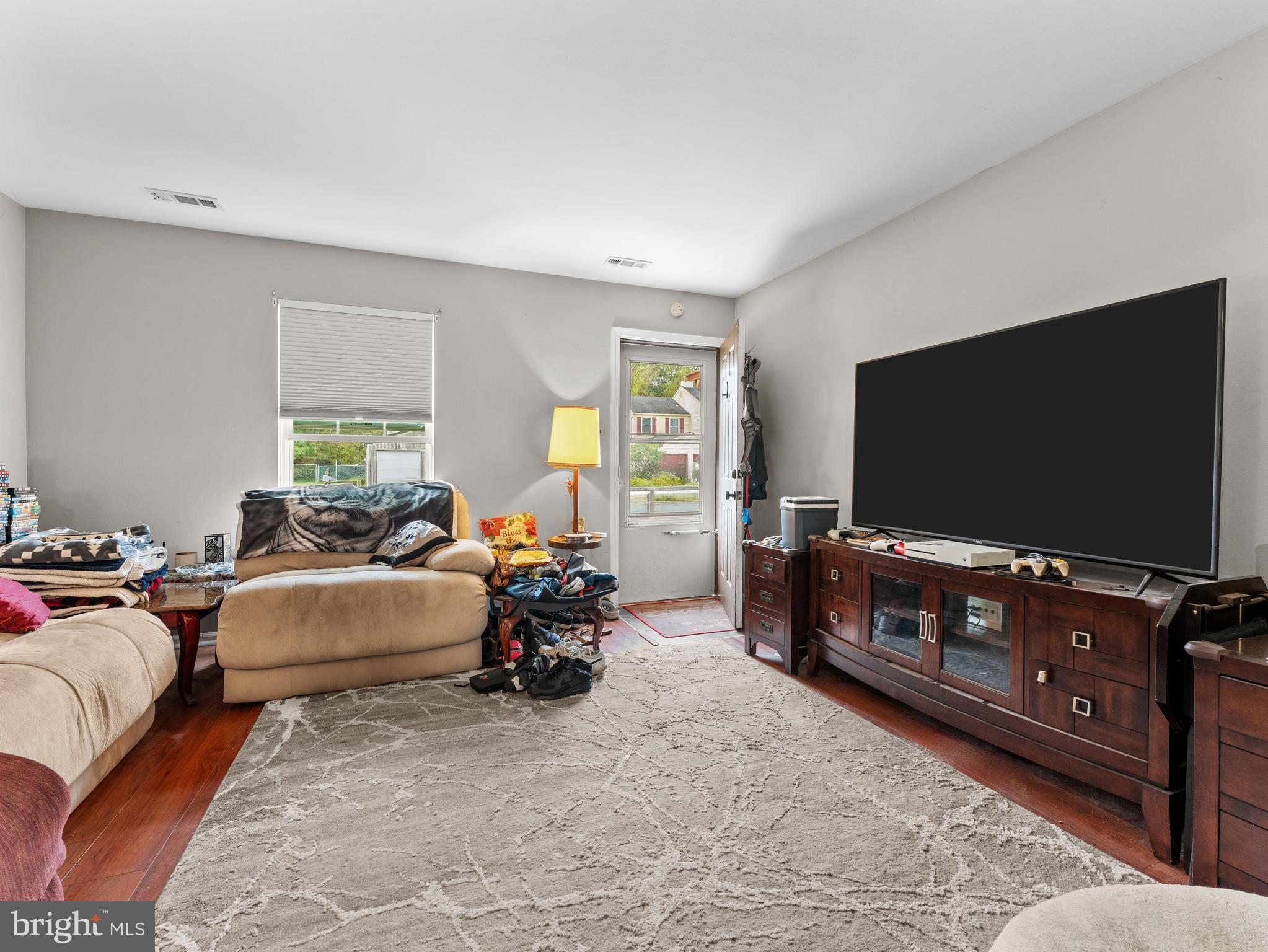 21 Maynard Drive Sicklerville, NJ 08081 - Photo 21 of 23 a living room with furniture and a flat screen tv