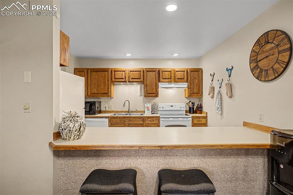 1140 Magic Lamp Way, Unit 3 Monument, CO 80132 - Photo 11 of 23 a view of kitchen with kitchen island a stove a table and chairs