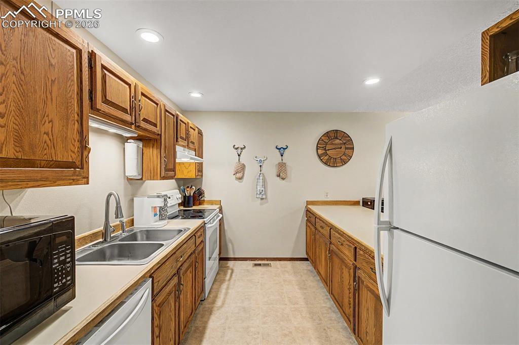 1140 Magic Lamp Way, Unit 3 Monument, CO 80132 - Photo 13 of 23 a kitchen with stainless steel appliances granite countertop a sink stove and refrigerator
