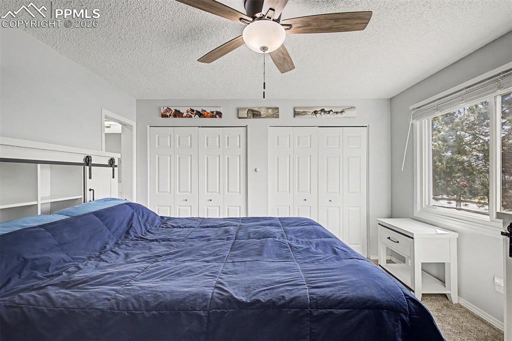 1140 Magic Lamp Way, Unit 3 Monument, CO 80132 - Photo 15 of 23 a bedroom with a bed and a window
