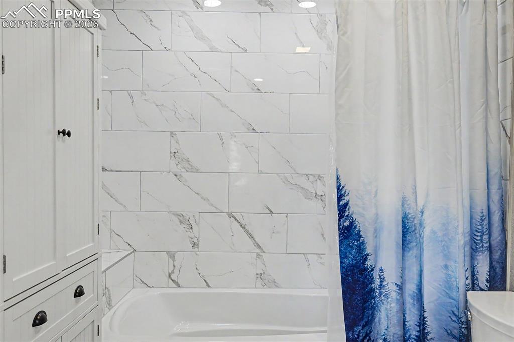 1140 Magic Lamp Way, Unit 3 Monument, CO 80132 - Photo 19 of 23 a bathroom with a bathtub and a shower