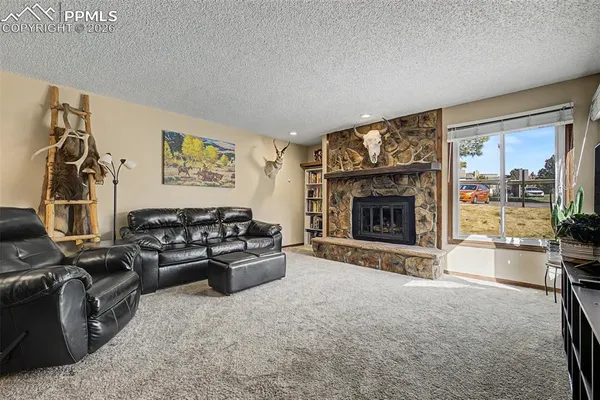 a living room with furniture and a fireplace