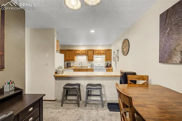 a room with a table chairs and a wooden floor