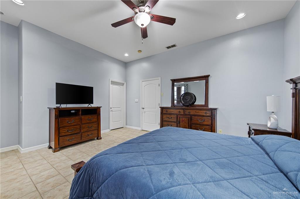 15474 Primera Road Harlingen, TX 78552 - Photo 15 of 45 a bedroom with a bed and a flat screen tv