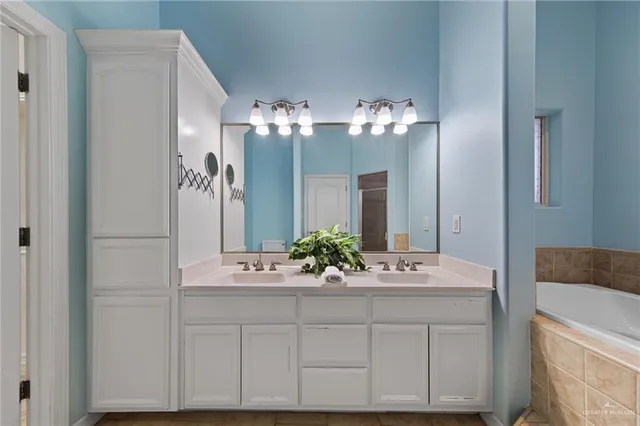 a bathroom with a sink vanity and a mirror