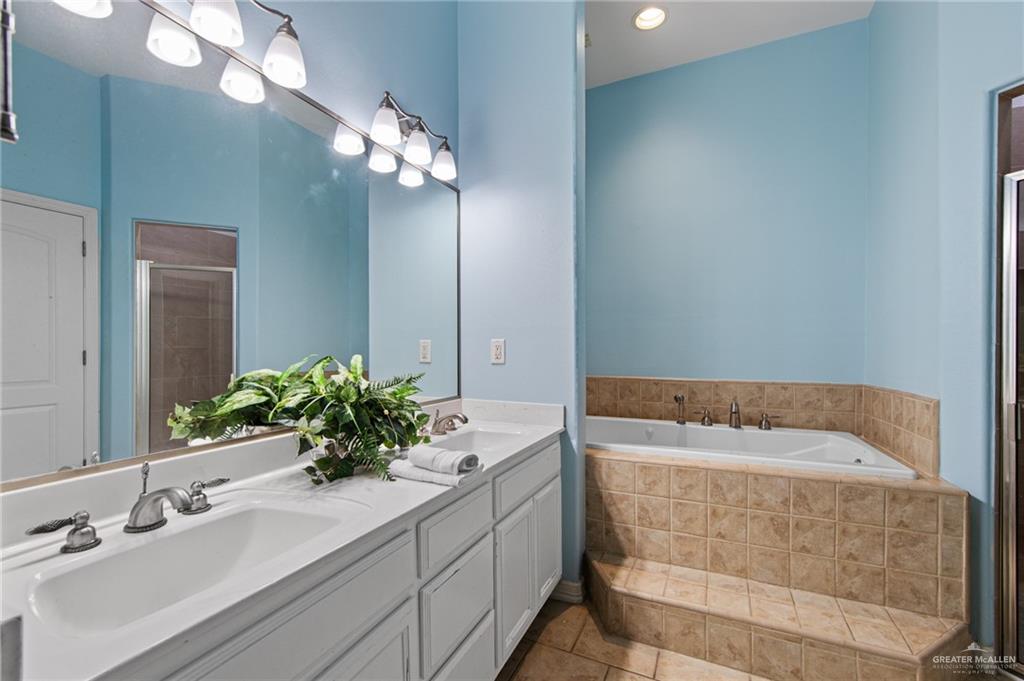 15474 Primera Road Harlingen, TX 78552 - Photo 17 of 45 a bathroom with a sink a vanity and a mirror
