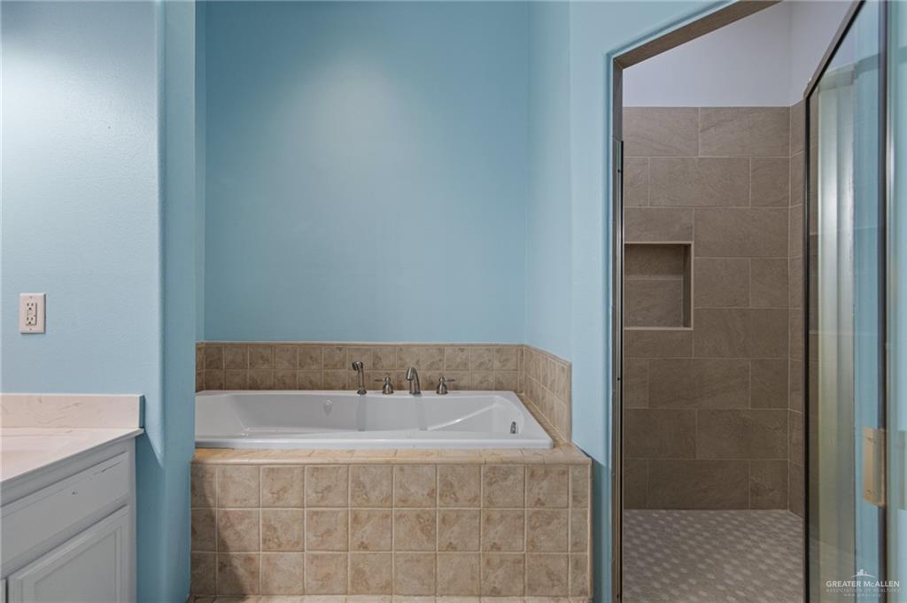 15474 Primera Road Harlingen, TX 78552 - Photo 18 of 45 a bathroom with a bathtub and shower