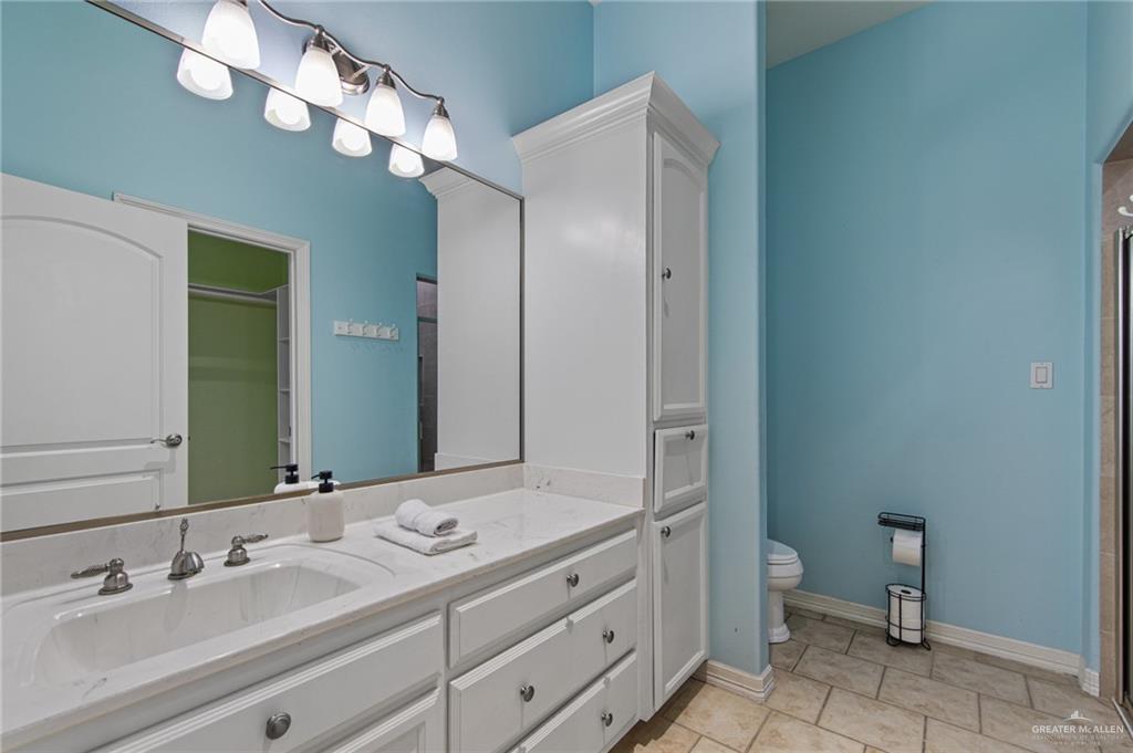 15474 Primera Road Harlingen, TX 78552 - Photo 22 of 45 a bathroom with a double vanity sink mirror and toilet