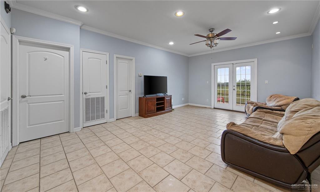 15474 Primera Road Harlingen, TX 78552 - Photo 27 of 45 a living room with furniture and a flat screen tv