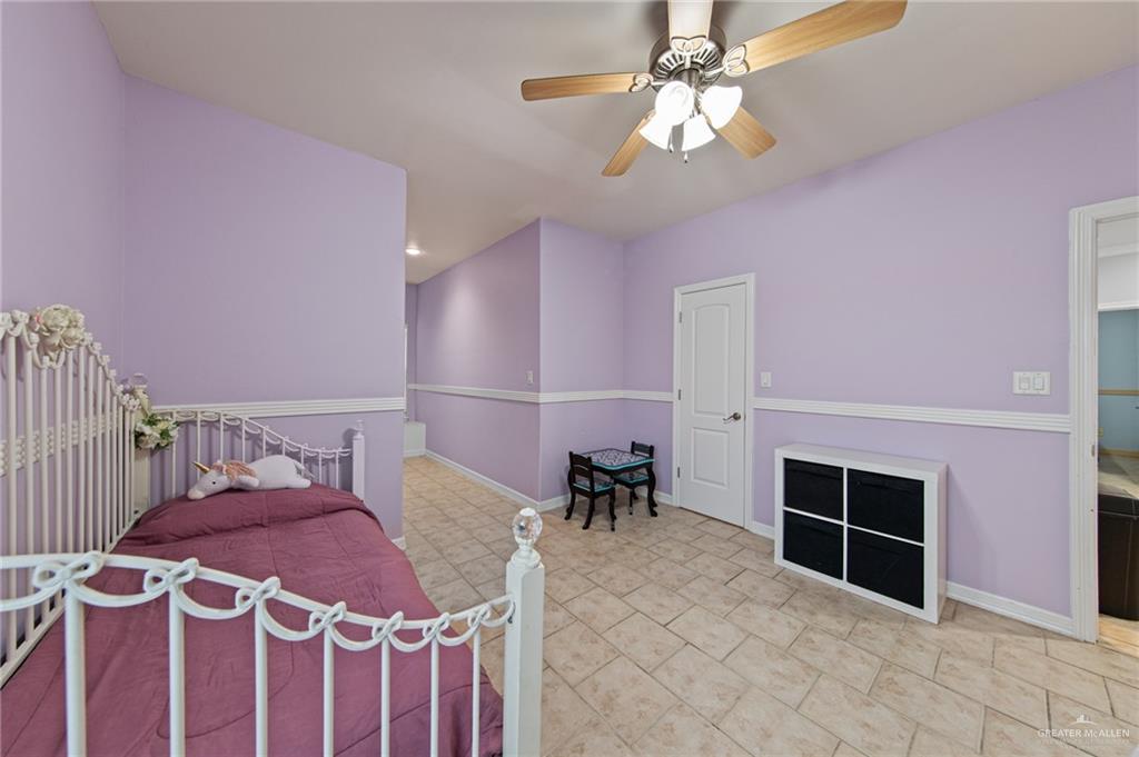 15474 Primera Road Harlingen, TX 78552 - Photo 30 of 45 a bedroom with furniture and a chandelier