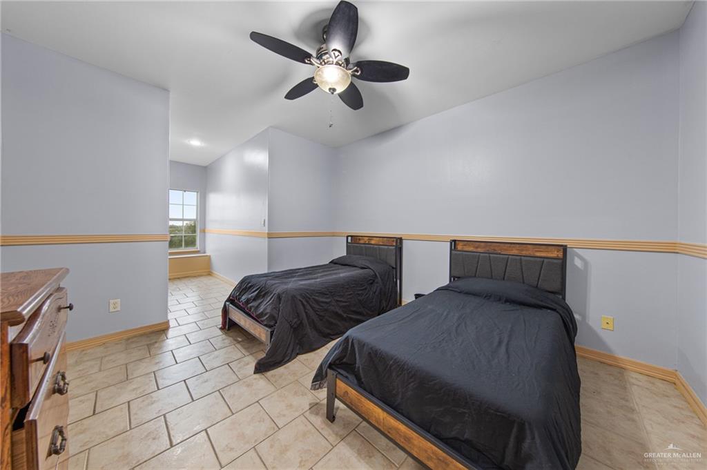 15474 Primera Road Harlingen, TX 78552 - Photo 31 of 45 a bedroom with two beds and painting on the wall