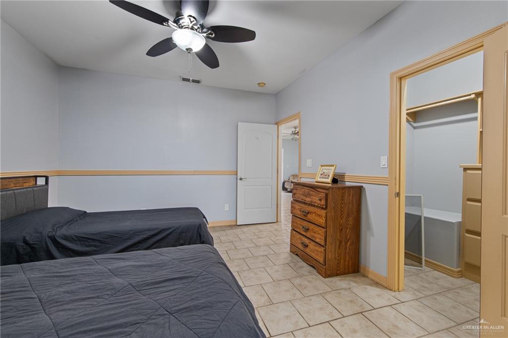 15474 Primera Road Harlingen, TX 78552 - Photo 32 of 45 a bedroom with a bed and cabinets