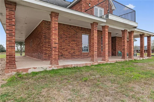 a view of a house with brick walls