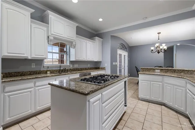 a kitchen with stainless steel appliances granite countertop a stove a sink dishwasher and a refrigerator