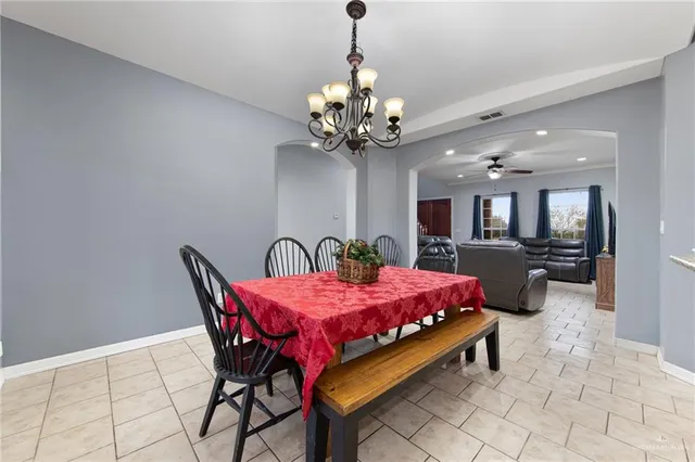 a dining room with furniture and chandelier