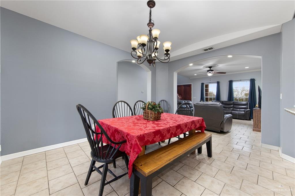 15474 Primera Road Harlingen, TX 78552 - Photo 8 of 45 a dining room with furniture and chandelier