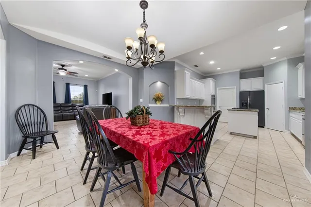 a view of a dining room with furniture and chandelier