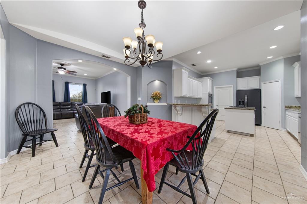 15474 Primera Road Harlingen, TX 78552 - Photo 9 of 45 a view of a dining room with furniture and chandelier