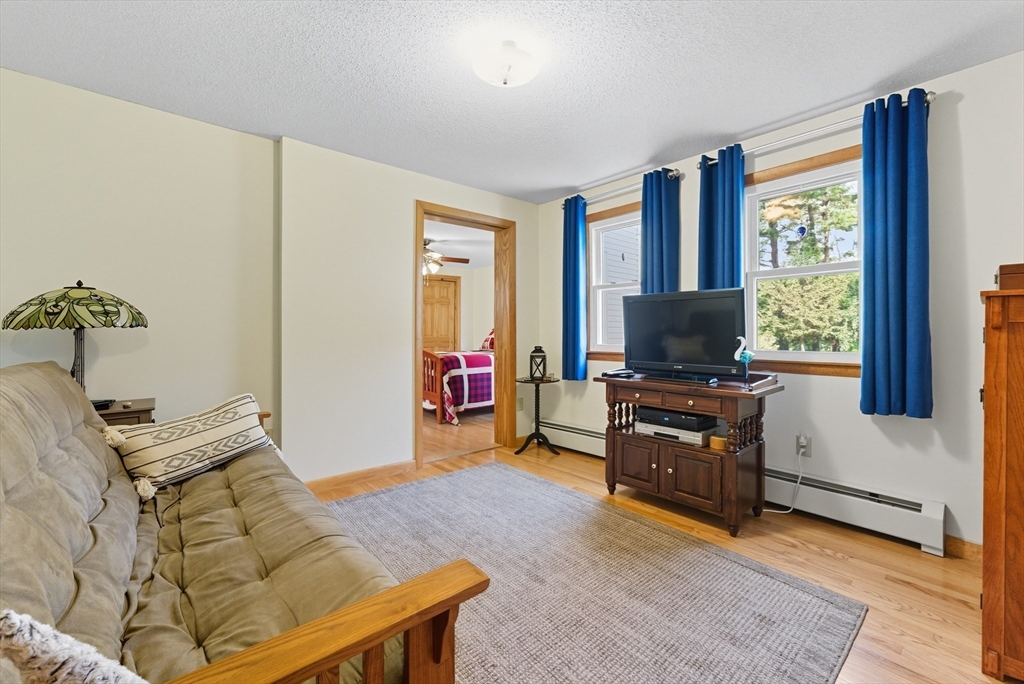 50 Martin Farms Road Hampden, MA 01036 - Photo 23 of 41 a living room with furniture and a flat screen tv