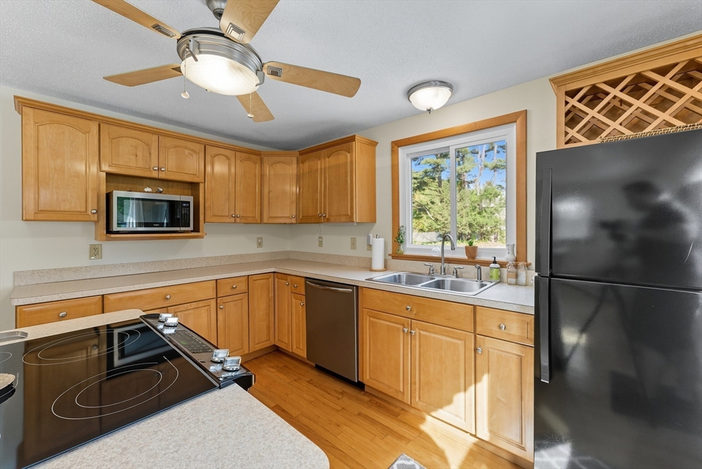 50 Martin Farms Road Hampden, MA 01036 - Photo 8 of 41 a kitchen with stainless steel appliances granite countertop a stove sink and cabinets