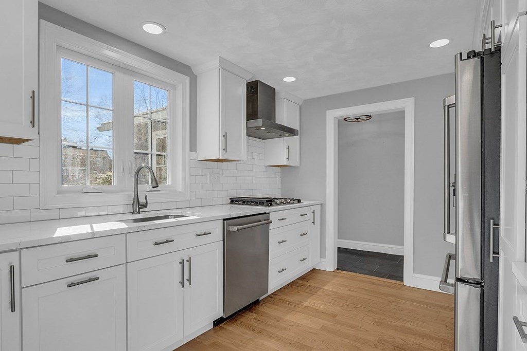 4 Radcliffe Road North Chelmsford, MA 01863 - Photo 12 of 40 a kitchen with stainless steel appliances granite countertop a stove and a sink