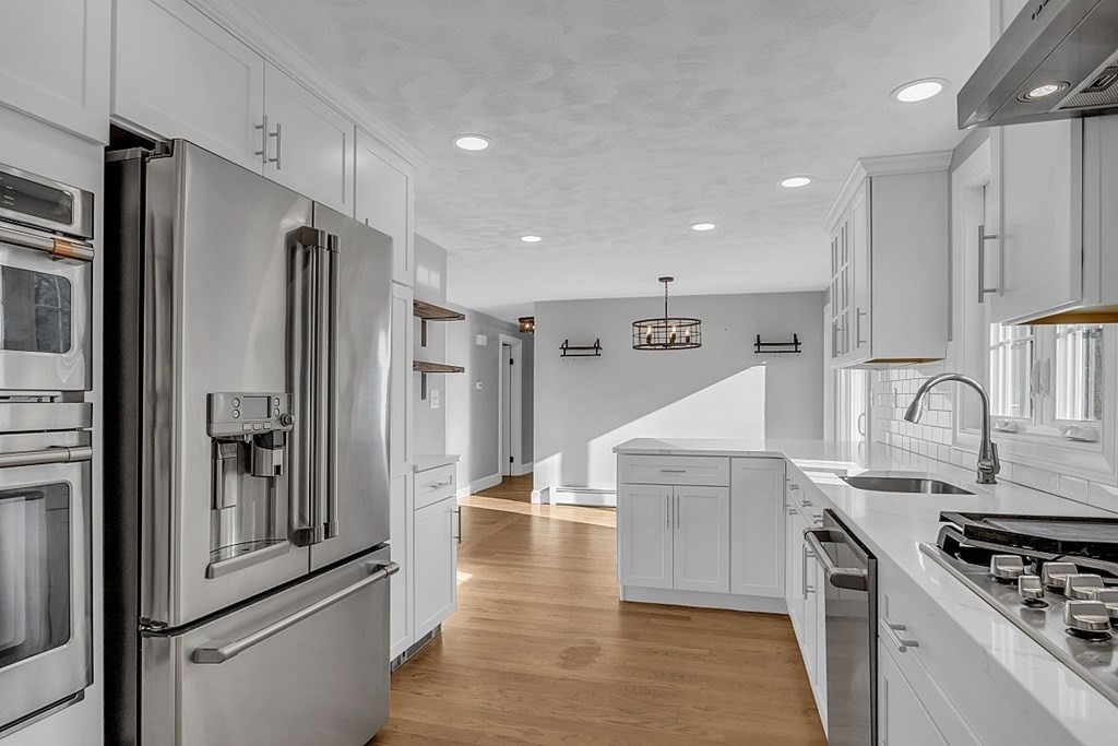 4 Radcliffe Road North Chelmsford, MA 01863 - Photo 13 of 40 a kitchen with stainless steel appliances granite countertop a refrigerator and a stove