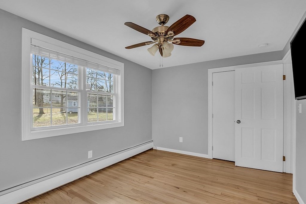 4 Radcliffe Road North Chelmsford, MA 01863 - Photo 27 of 40 a view of an empty room with wooden floor and a window