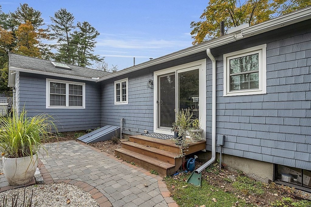 4 Radcliffe Road North Chelmsford, MA 01863 - Photo 37 of 40 a wooden bench sitting in front of a house