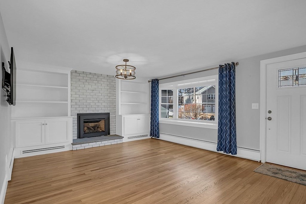 4 Radcliffe Road North Chelmsford, MA 01863 - Photo 7 of 40 wooden floor fireplace and windows in an empty room
