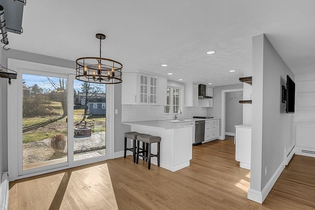 4 Radcliffe Road North Chelmsford, MA 01863 - Photo 10 of 40 a view of a kitchen and a chandelier