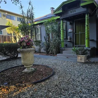 a view of a house that has a flower garden