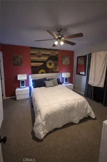 a bedroom with a bed and a wall painting