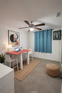 a living room with chairs and a table