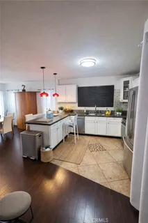 a large white room with a couch and a flat screen tv