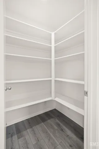 a kitchen with white cabinets and sink