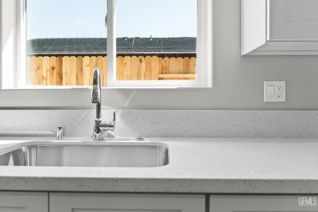 a kitchen with granite countertop a stove and a microwave