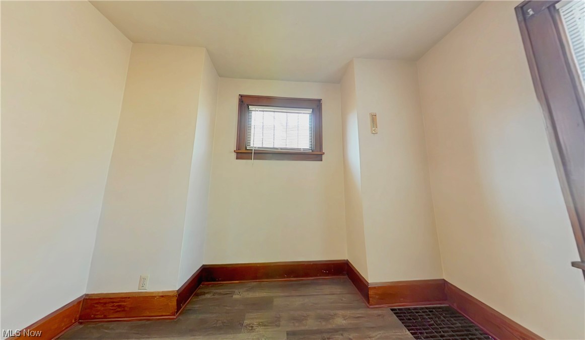 Dining room with dark hardwood / wood-style flooring