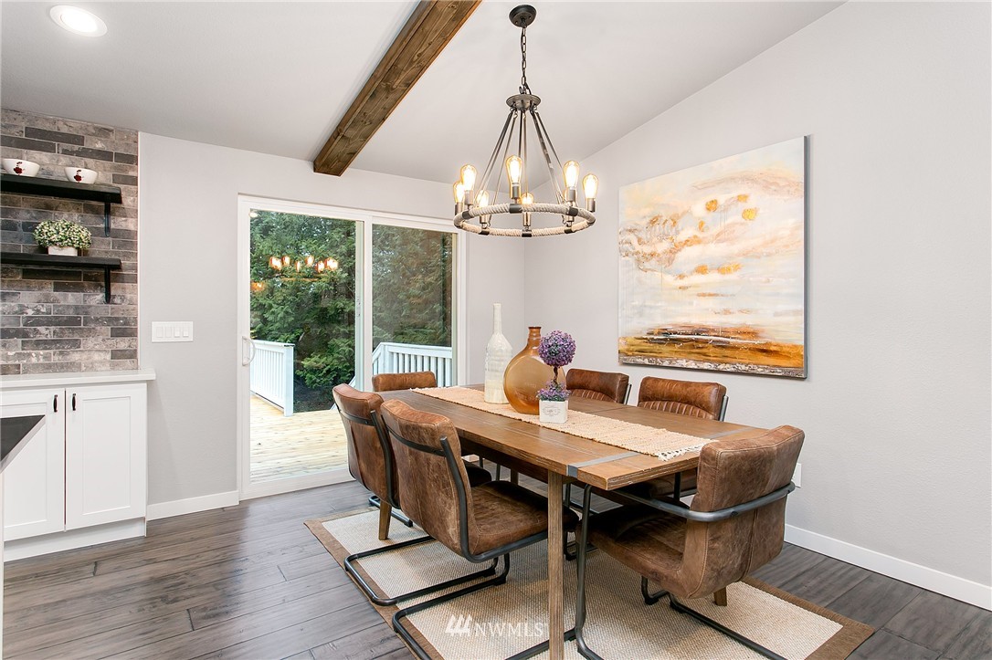 23028 35th Avenue Southeast Bothell, WA 98021 - Photo 11 of 25 a dining room with furniture a chandelier and wooden floor