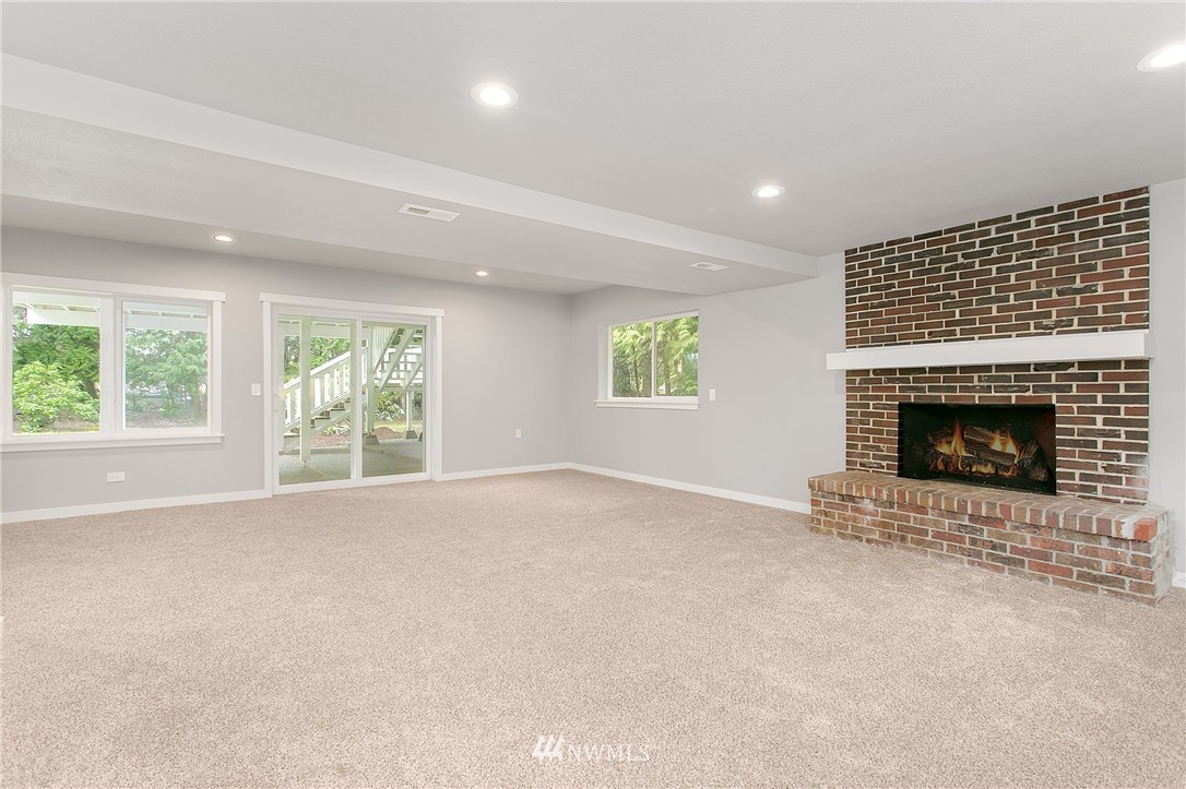 23028 35th Avenue Southeast Bothell, WA 98021 - Photo 19 of 25 an empty room with windows and fireplace