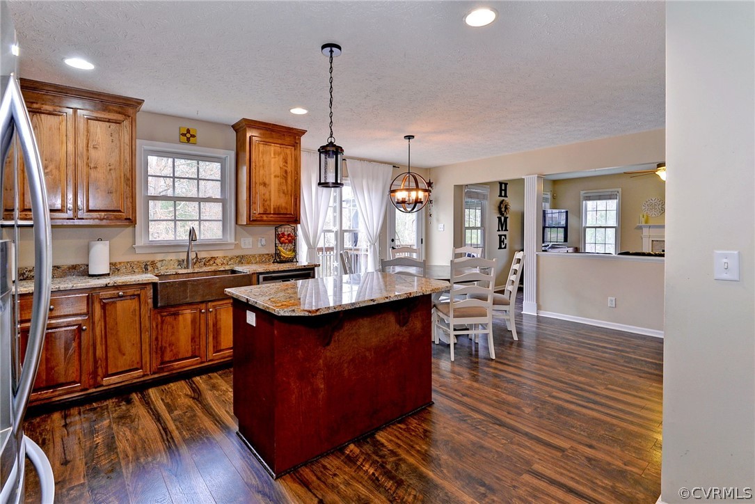 8416 Down Patrick Way Williamsburg, VA 23188 - Photo 11 of 47 a kitchen with stainless steel appliances granite countertop wooden floors sink stove and wooden cabinets