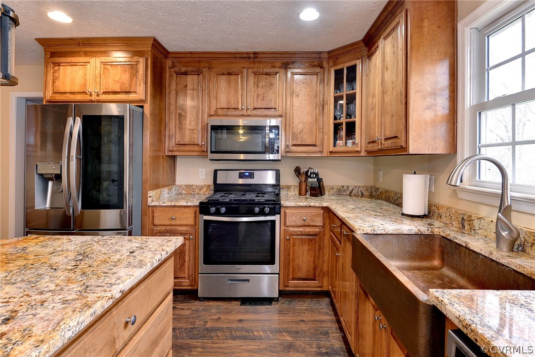 8416 Down Patrick Way Williamsburg, VA 23188 - Photo 14 of 47 a kitchen with stainless steel appliances granite countertop a stove a sink and a microwave