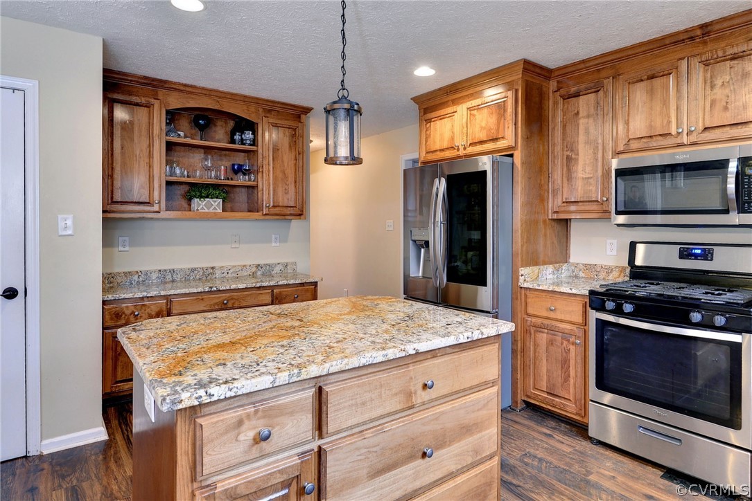 8416 Down Patrick Way Williamsburg, VA 23188 - Photo 15 of 47 a kitchen with stainless steel appliances granite countertop a stove and a refrigerator