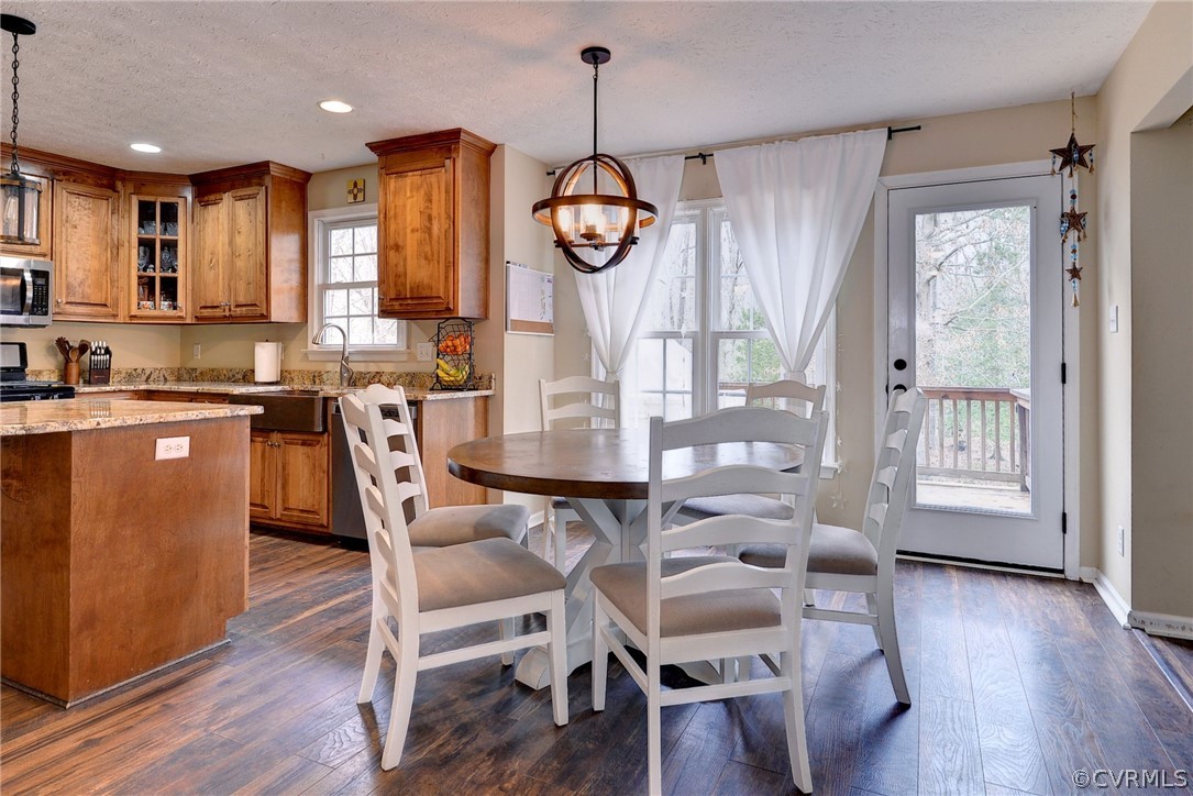 8416 Down Patrick Way Williamsburg, VA 23188 - Photo 16 of 47 a view of a dining room with furniture window and wooden floor
