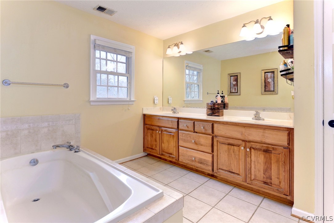 8416 Down Patrick Way Williamsburg, VA 23188 - Photo 27 of 47 a bathroom with a sink and a bathtub