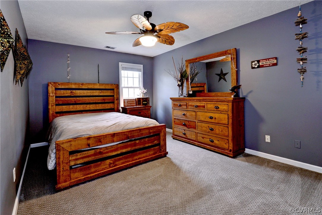 8416 Down Patrick Way Williamsburg, VA 23188 - Photo 29 of 47 a bed room with a bed and a ceiling fan