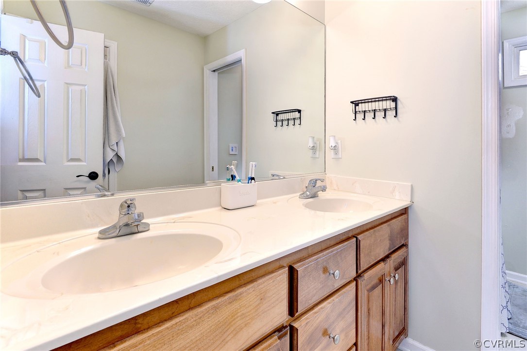 8416 Down Patrick Way Williamsburg, VA 23188 - Photo 30 of 47 a bathroom with a sink and a mirror