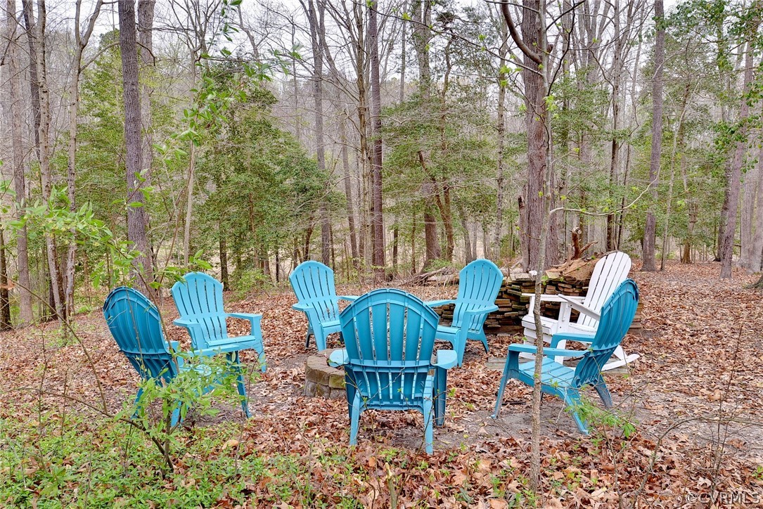 8416 Down Patrick Way Williamsburg, VA 23188 - Photo 37 of 47 a view of a chairs and table in backyard