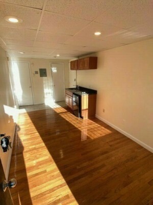 507 Beacon Street, Unit C Boston, MA 02215 - Photo 2 of 5 a bedroom with a bed and wooden floor